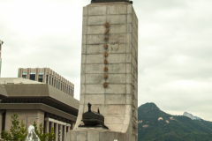 Admiral Yi looking at a boy playing in the water.